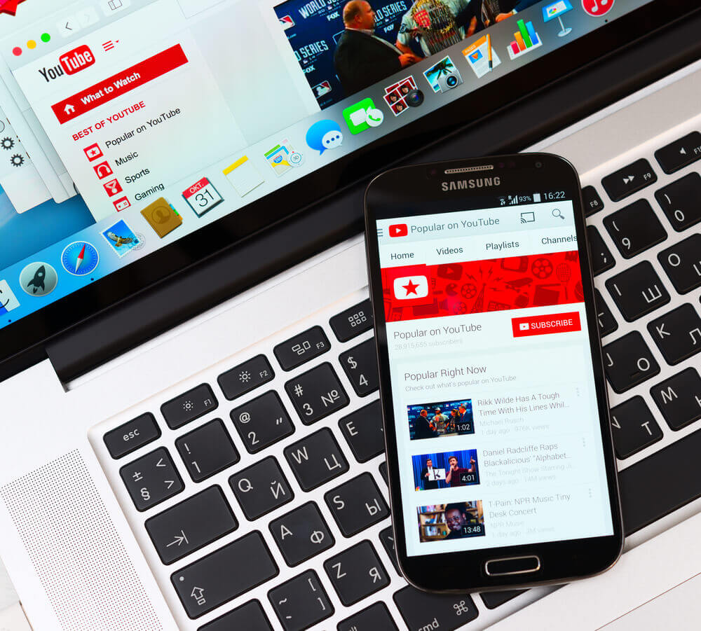 YouTube on laptop and phone screens