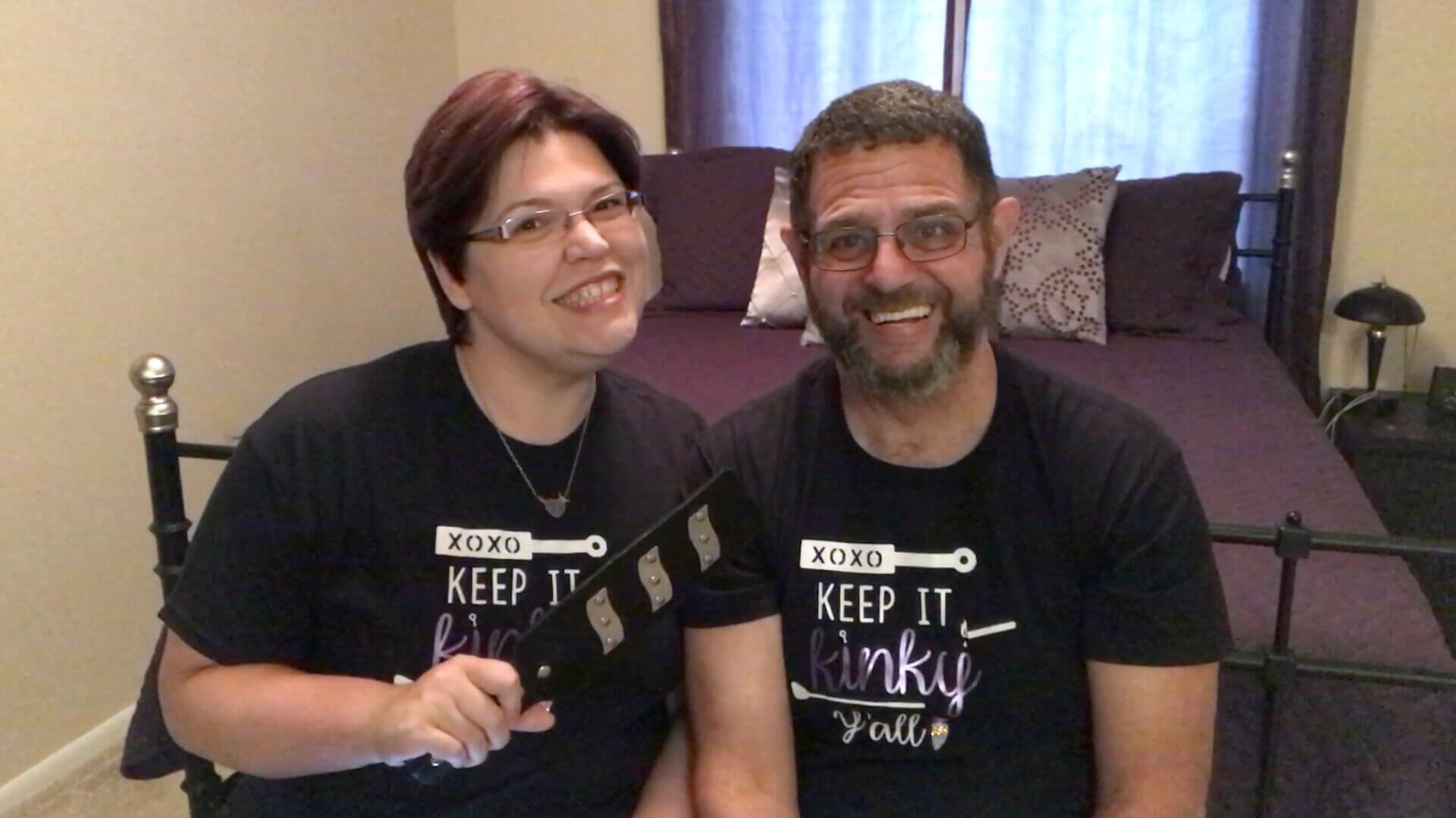 Kayla Lords and John Brownstone smiling -- Kayla holds the ElectraPaddle -- for our review of ElectraStim AXIS