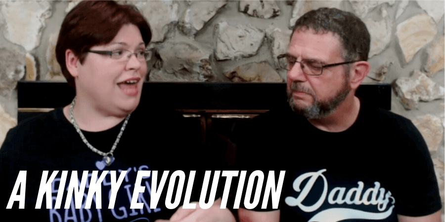 screen shot from video of Kayla Lords and John Brownstone looking at each other and discussing their first scene in a BDSM dungeon with the caption "A Kinky Evolution"