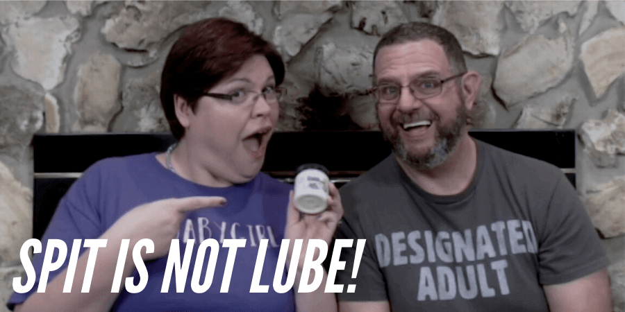 picture of Kayla Lords holding jar of Palm Grease lube sitting next to John Brownstone with title spit is not lube!