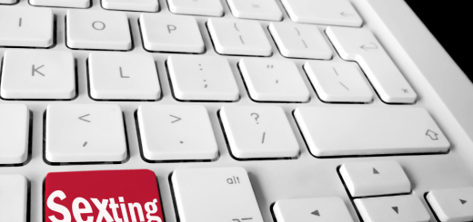 white keyboard with red key that says sexting